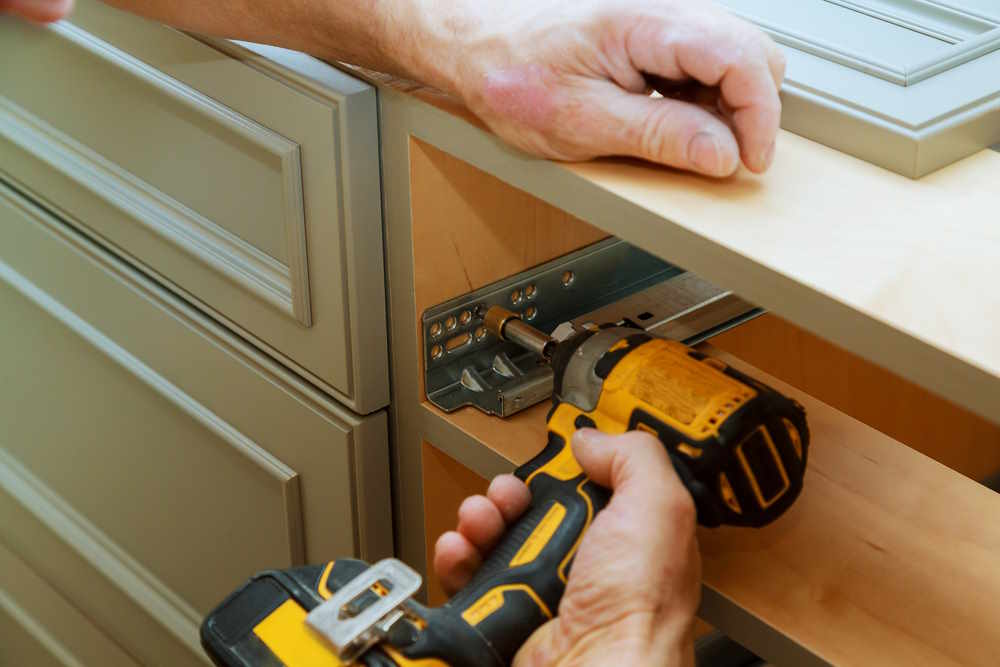 Carpenter services fixing a drawer slider Carpentry services